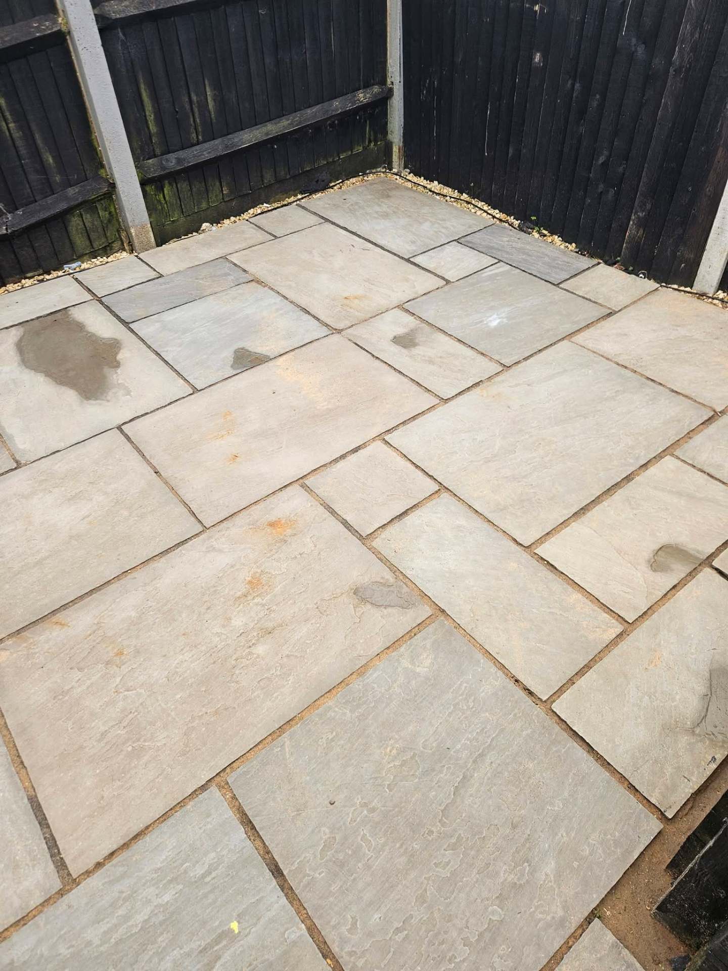 Indian sandstone patio restored with controlled-pressure jet washing — no zebra striping